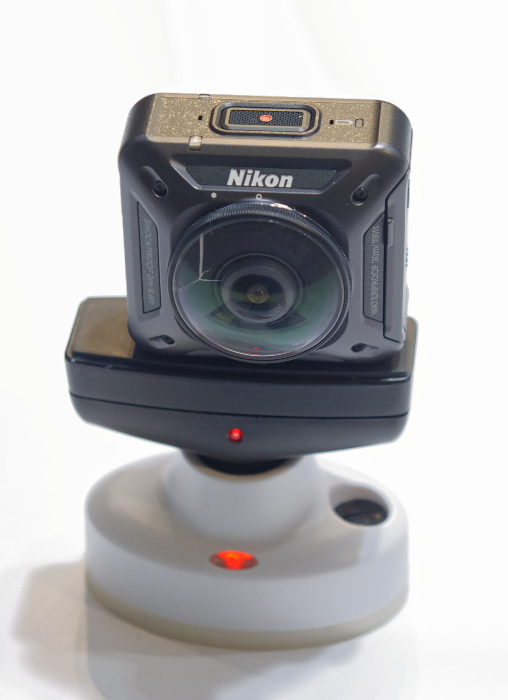 Nikon KeyMission 360 on a display stand at Photokina 2016, showing its front lens and top recording button