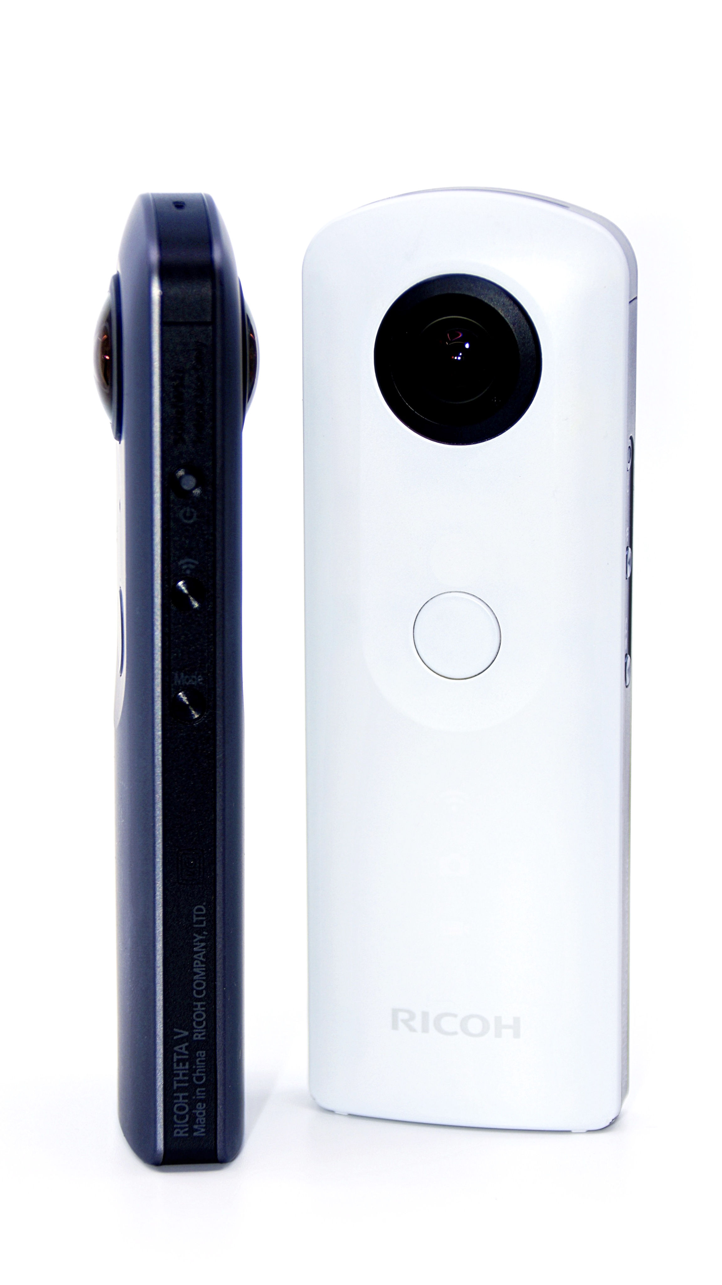 White Ricoh Theta SC facing forward on the right, beside a dark Theta V viewed from the side on the left