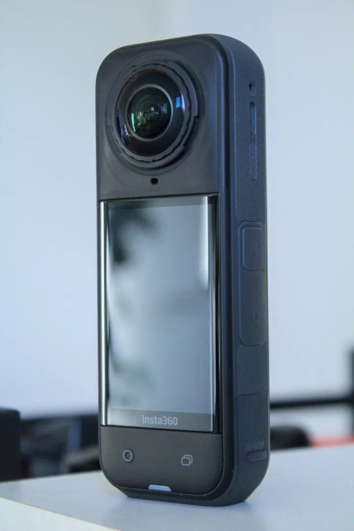 Insta360 X5 viewed from its touchscreen side
